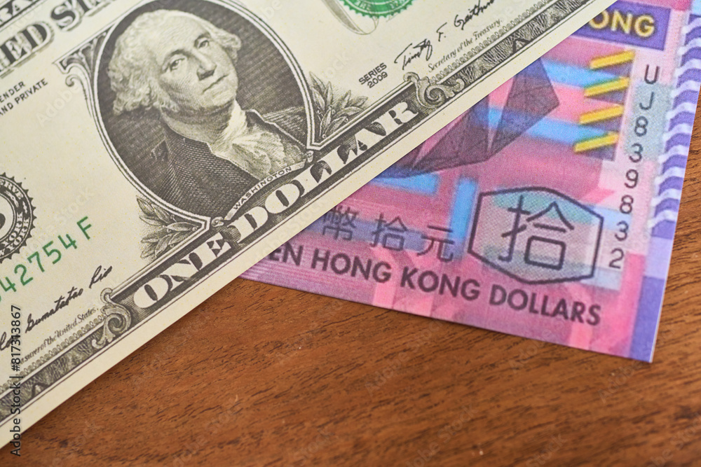 Comparison of dollar bill with hong kong dollar, concept of inflation or abundance Comparison of dollar bill with hong kong dollar, concept of inflation or abundance