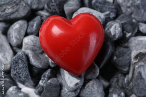 Red decorative heart on stones, closeup view