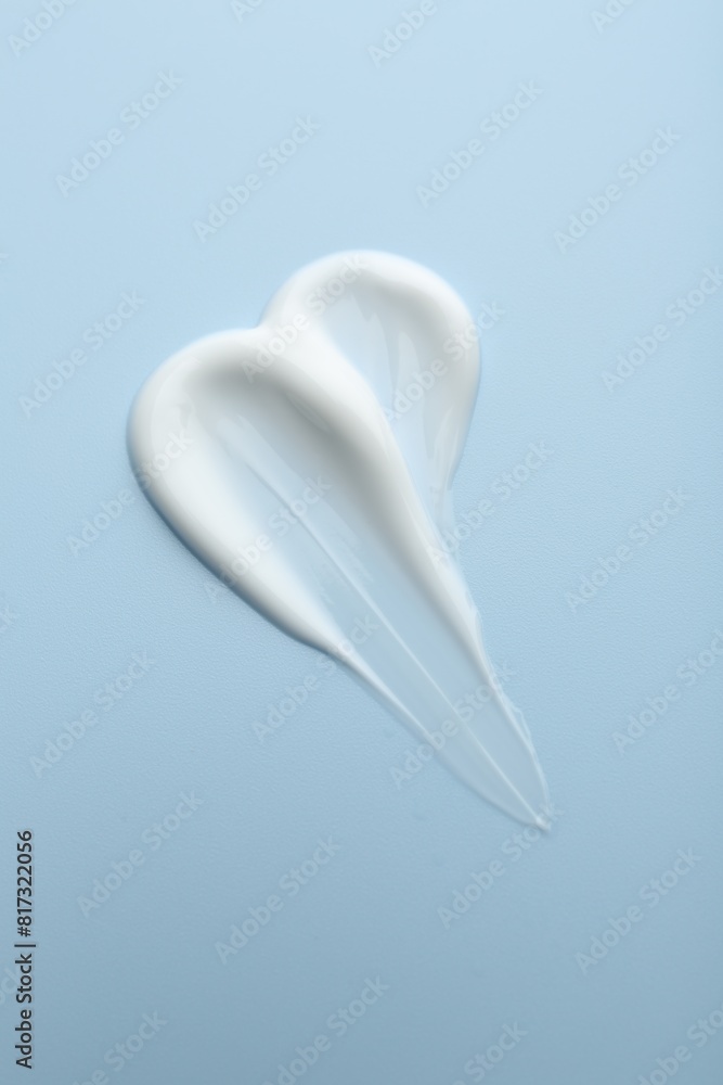 Sample of face cream on light blue background, top view Sample of face cream on light blue background, top view