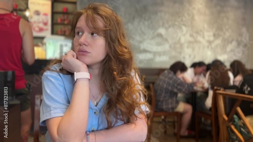 young woman is afraid of people around, social phobia in a cafe or restaurant, social anxiety,public place, privacy