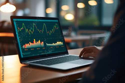 Close up of businessman using a laptop with graphs and charts on a laptop computer. Close up of businessman using a laptop with graphs and charts on a laptop computer. The mans hands can seen typing 