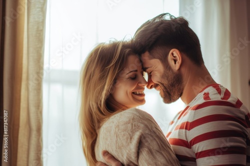 Close up shot of a cheerful couple braced in an intimate loving hug at home