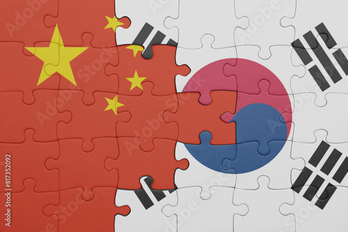puzzle with the colourful national flag of south korea and flag of china . photo