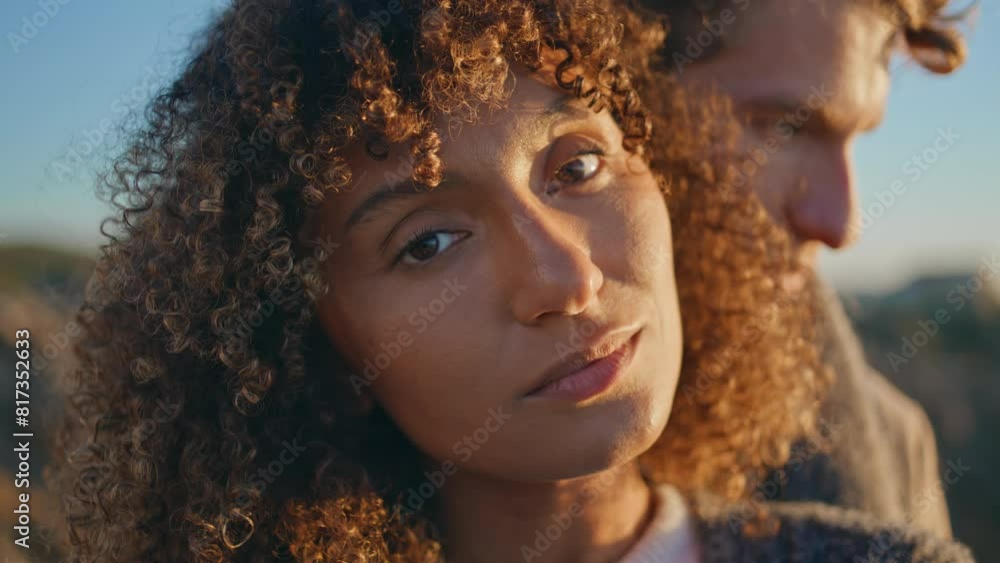 Enamoured woman looking camera at sunset nature portrait. Diverse lovers faces Enamoured woman looking camera at sunset nature portrait. Diverse lovers faces