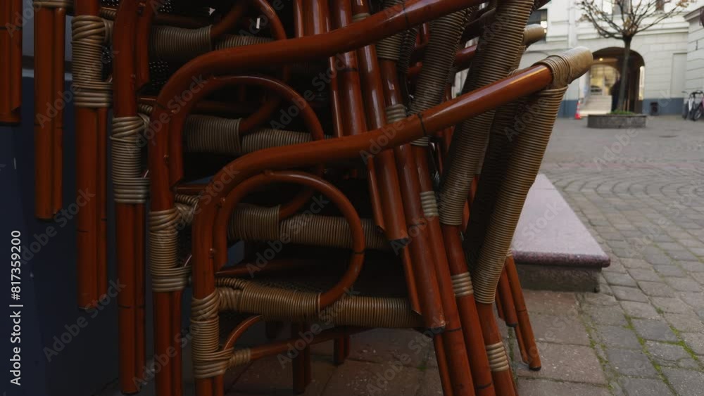 Terrace view of wicker chairs stacked in a restaurant Terrace view of wicker chairs stacked in a restaurant