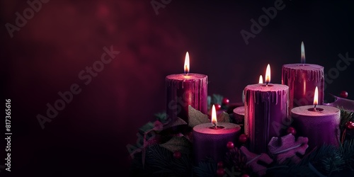 A set of purple lit candles with holiday decorations creating a festive and warm atmosphere