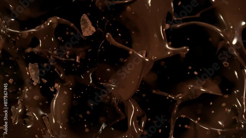 Super Slow Motion Shot of Chocolate Chunks Followed by Camera Falling into Chocolate Cream, 1000fps. photo