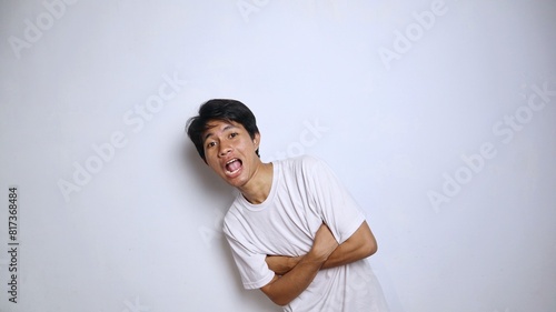 Handsome young Asian man in white shirt with crossed arms