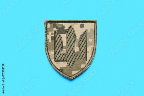 Military badge of Ukrainian army with trident on blue background