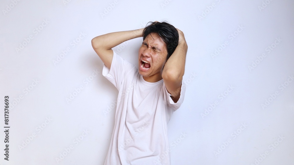 young asian man in white shirt with expression dizzy, stressed, depressed, mentally damaged, lost, hand gesture holding head i young asian man in white shirt with expression dizzy, stressed, depressed, mentally damaged, lost, hand gesture holding head i