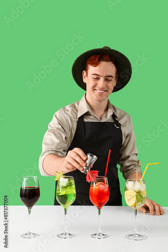 Young male bartender prepar...