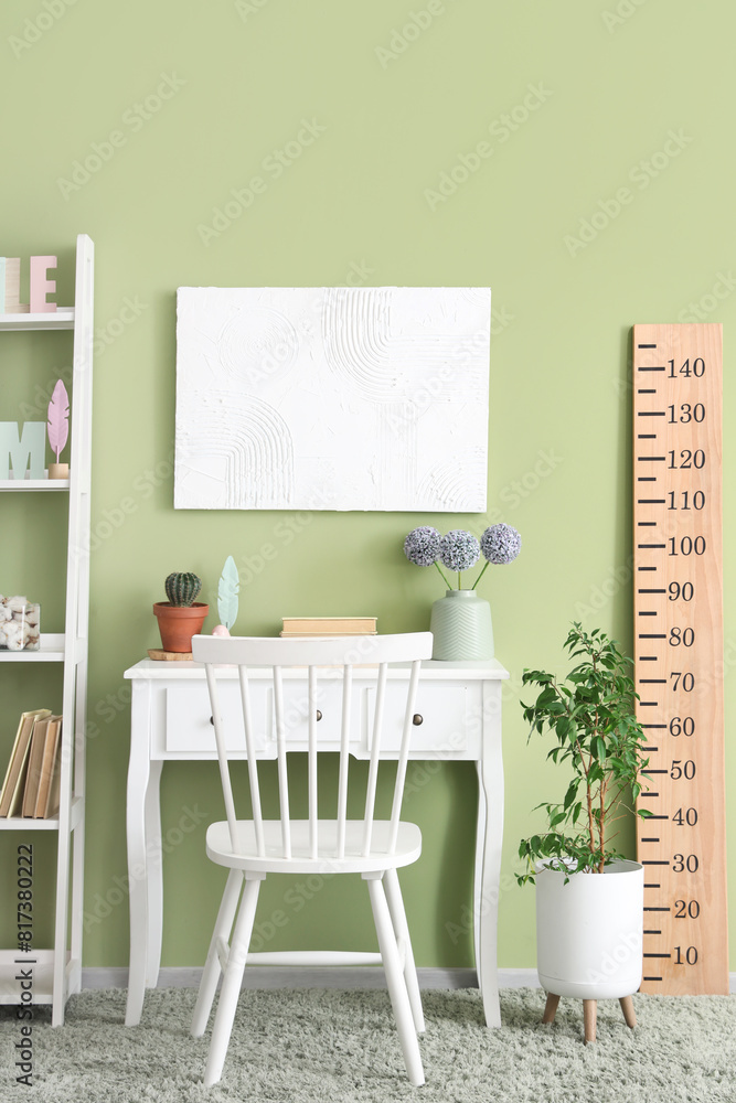 Modern children's room interior with comfortable workspace and wooden stadiometer Modern children's room interior with comfortable workspace and wooden stadiometer