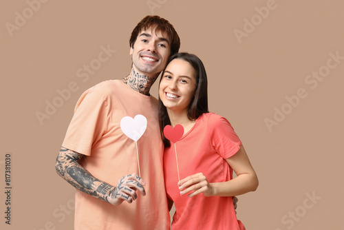 фотографія Happy young couple holding heart shaped cards, love and relationship concept, va