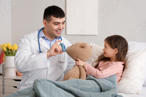 Male pediatrician with inha...