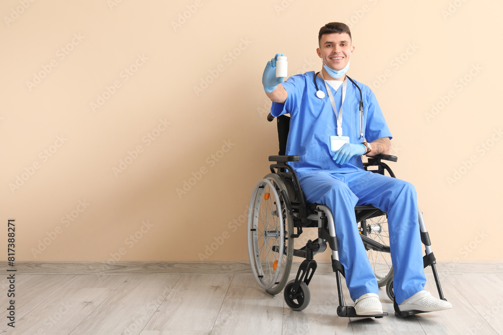 Young male doctor in wheelchair with medical mask and pills near beige wall Young male doctor in wheelchair with medical mask and pills near beige wall