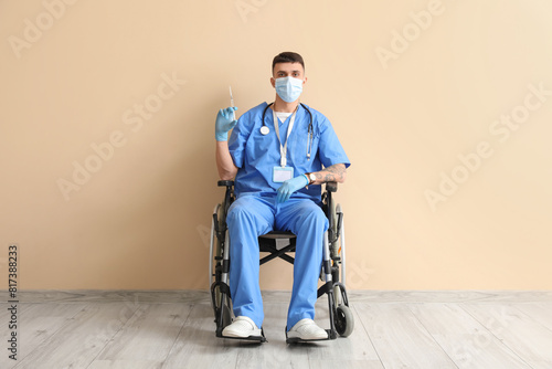 Young male doctor in wheelc...