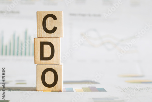 CDO - text on wooden cubes, on office table background. collateralized debt obligations or chief data officer concept