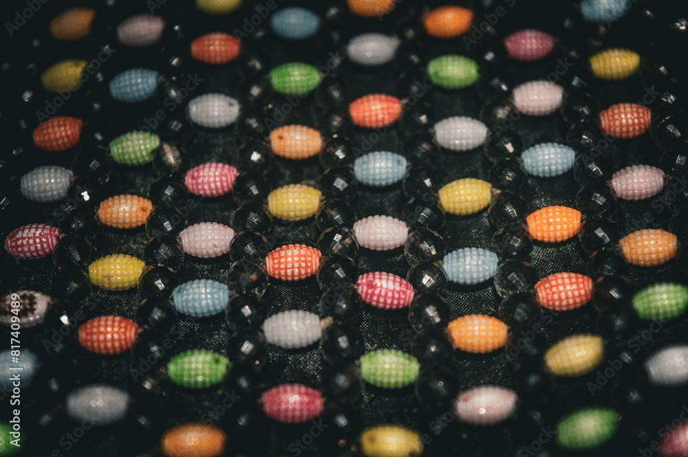 colorful mote berry beads attached to a women's bag colorful mote berry beads attached to a women's bag