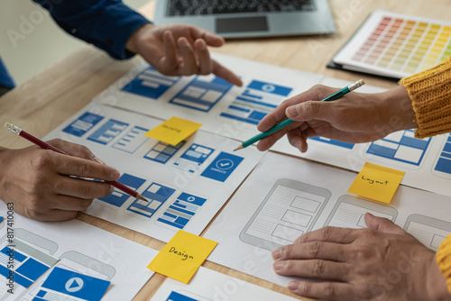 A team of UX designers works on a new website layout. Plan mobile web application development in prototyping. Developing products and adding new ideas, close-up shots