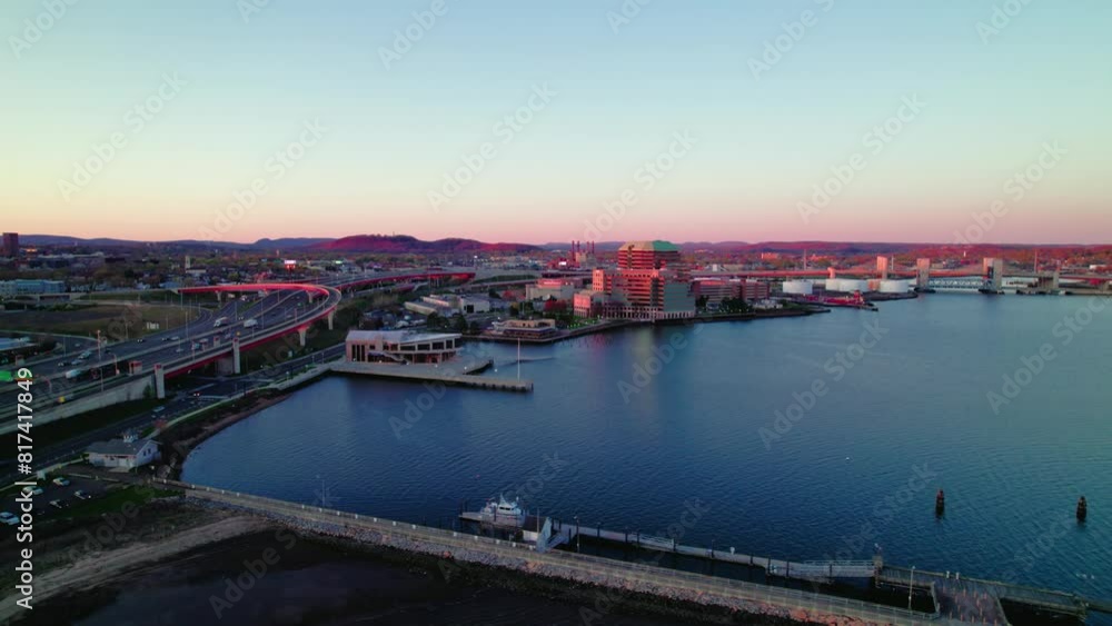 Twilight aerial shot over New Haven, CT, highlighting the city's roads and harbor at sunset. Q Bridge and Tomlinson Bridge United States Twilight aerial shot over New Haven, CT, highlighting the city's roads and harbor at sunset. Q Bridge and Tomlinson Bridge United States