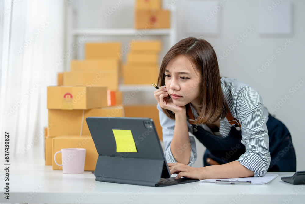 A woman is sitting at a desk with a laptop and a clipboard A woman is sitting at a desk with a laptop and a clipboard