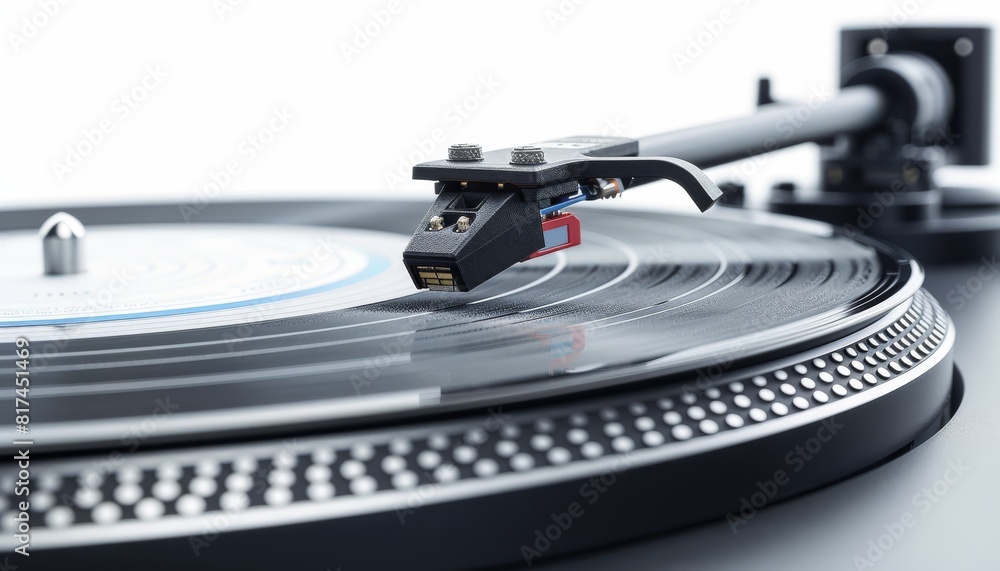 Close up of a record player playing music on a vinyl turntable against an isolated white background. A closeup of the needle and tonearm from which black grooves run through the platter Close up of a record player playing music on a vinyl turntable against an isolated white background. A closeup of the needle and tonearm from which black grooves run through the platter