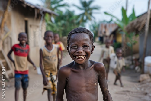 Unidentified local boy smiles at the local village. People in G.-Bissau suffer of poverty due to the bad economy photo