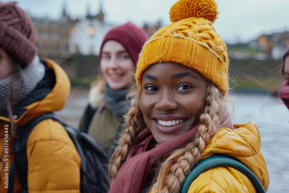 Group of happy multiethnic friends having fun outdoors. Cheerful african american woman with dreadlocks in yellow hat and scarf looking at camera Group of happy multiethnic friends having fun outdoors. Cheerful african american woman with dreadlocks in yellow hat and scarf looking at camera