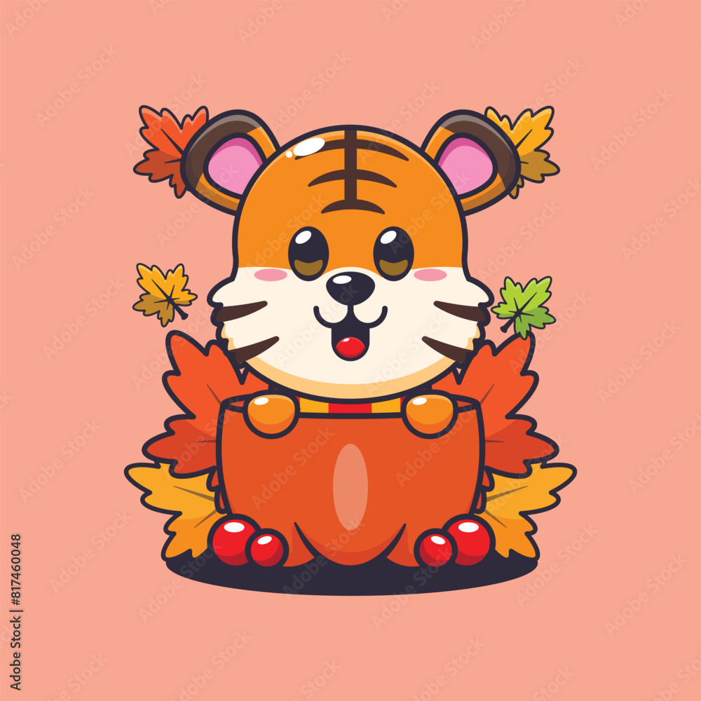 Cute tiger in a pumpkin at autumn season