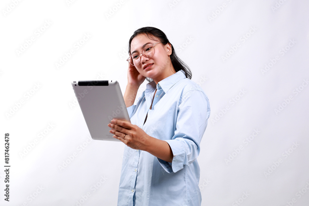 Portrait of asian business woman looking at digital tablet with worried, stressed and upset face. Isolated on white Portrait of asian business woman looking at digital tablet with worried, stressed and upset face. Isolated on white