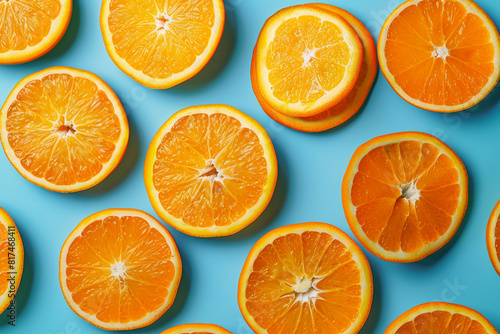 Slices of juicy orange on light blue background.