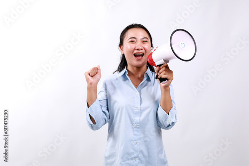 Announcement. Happy asian woman shouting loud at megaphone, recruiting, protesting with speaker in hands, standing over white background © SetianingDyah