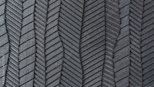 close-up view of sole of shoe pattern, abstract of black rubber textured and grooves surface of bottom of footwear in full frame, macro background or wallpaper for designing photo