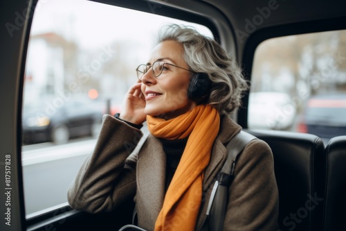mature woman talking on phone during commute