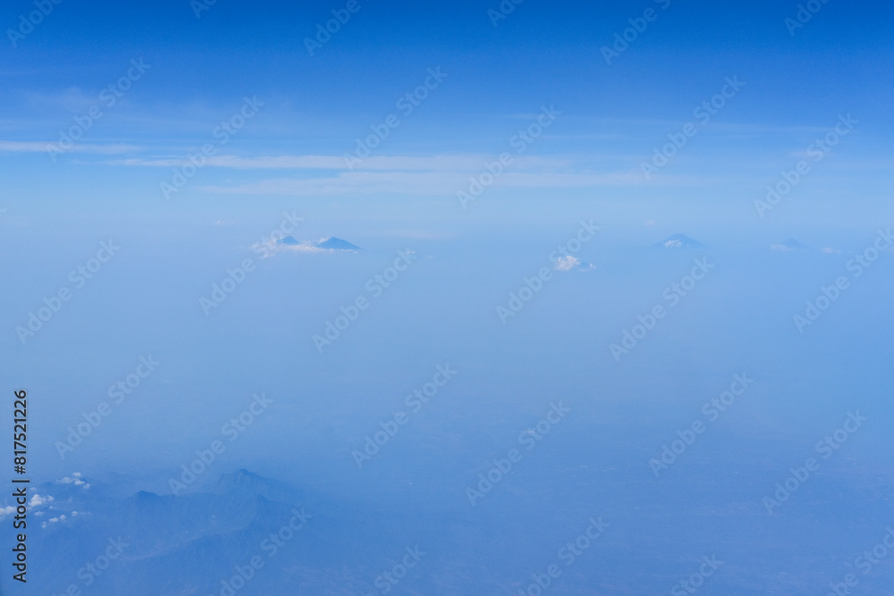 view of the bright blue sky and mountains on the island of Java from the plane window, blue sky with clouds, See Through Plane Window With Blue Sky And Clouds Outside, travel trip over Java island view of the bright blue sky and mountains on the island of Java from the plane window, blue sky with clouds, See Through Plane Window With Blue Sky And Clouds Outside, travel trip over Java island