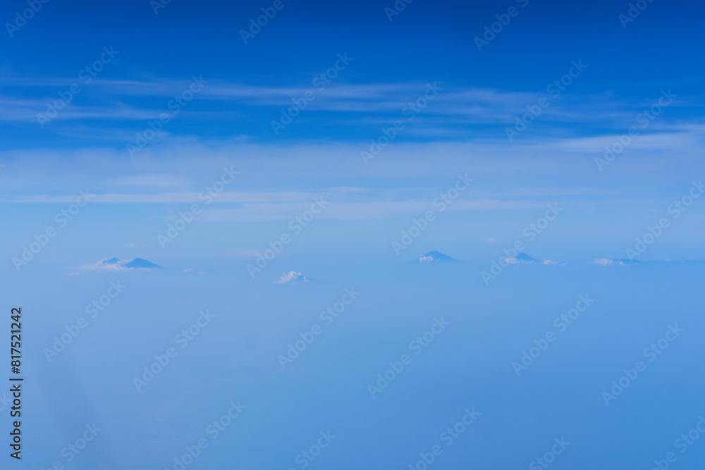 view of the bright blue sky and mountains on the island of Java from the plane window, blue sky with clouds, See Through Plane Window With Blue Sky And Clouds Outside, travel trip over Java island view of the bright blue sky and mountains on the island of Java from the plane window, blue sky with clouds, See Through Plane Window With Blue Sky And Clouds Outside, travel trip over Java island
