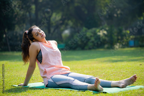 After Doing Yoga, Asian Young Woman Relaxes in the Park.
