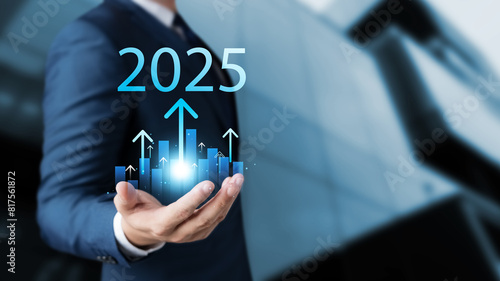 Set business goals for 2025, businessman holds up arrow charging graph Show business growth with text 2025, implementation of business goals plan, development to achieve prosperity and success.