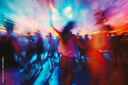 Friends dancing at a music festival, with colorful trails and blurred lights conveying euphoria and excitement photo