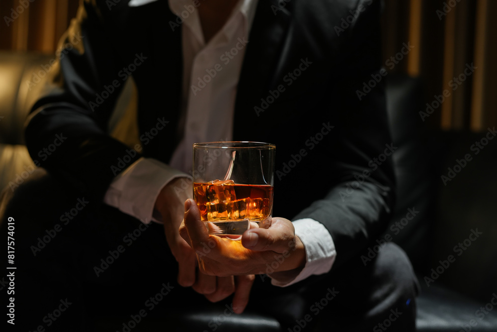 businessmen holding a glass of whiskey businessmen holding a glass of whiskey
