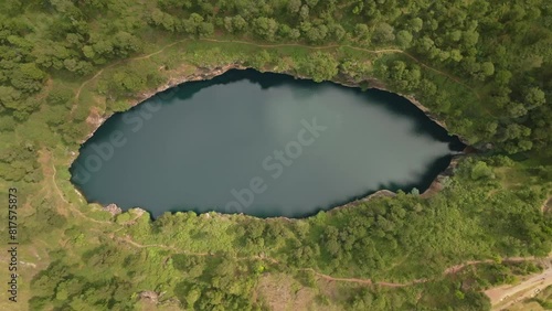 Aerial drone top down view of Tritriva volcanic lake in crater located in countryside near Antsirabe in Madagascar. (4K) photo