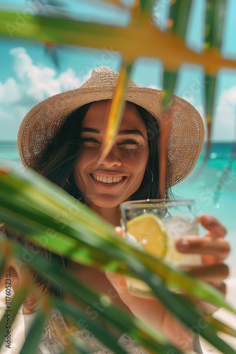 A cocktail in the hands of a girl on the beach. Selective focus.