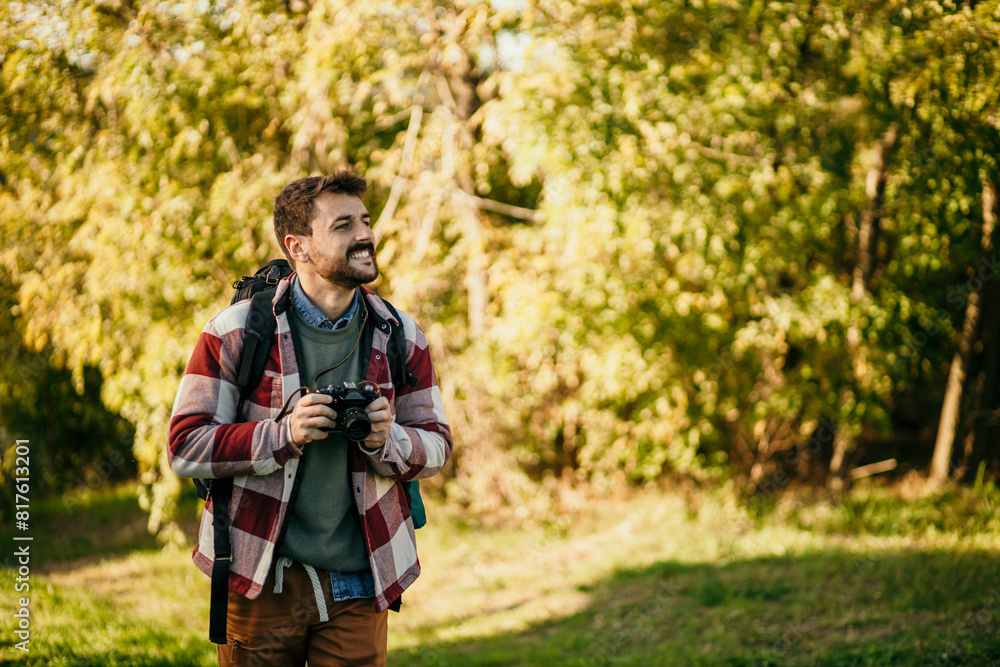 Backpacker and photographer navigating the trails of picturesque golden hills Backpacker and photographer navigating the trails of picturesque golden hills