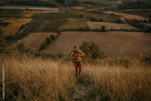 A young boy out walking high upon a hill with a backpack © La Famiglia