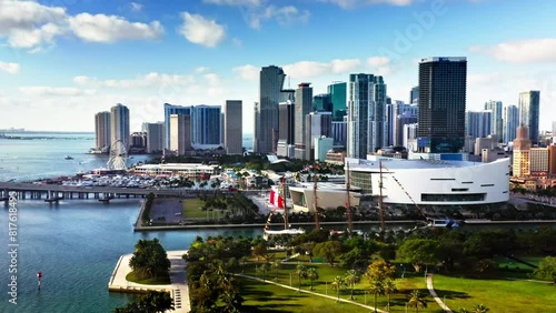 4k view from above of colorful cityscape of metropolis. Skyscrapers with glass and concrete of downtown Miami. Modern architecture. Green park, blue water, luxury yachts, on coast of bay on sunny day
