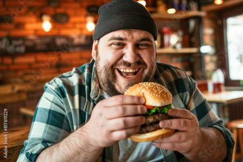 A joyful  overweight man savoring a burger in a lively caf    radiating contentment and enjoyment.