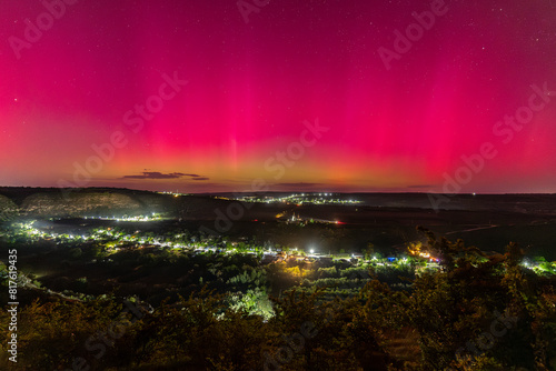 Obraz na płótnie beautiful view on church on hill and village of butuceni in old orhei in moldova under bright pink purple green aurora borealis northern lights at night w salonie