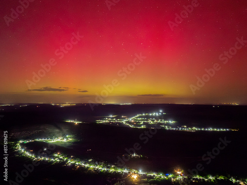 aerial view over orheiul vechi old orhei in butuceni historical place with church on cliff at night under bright rose green purple aurora borealis northern lights