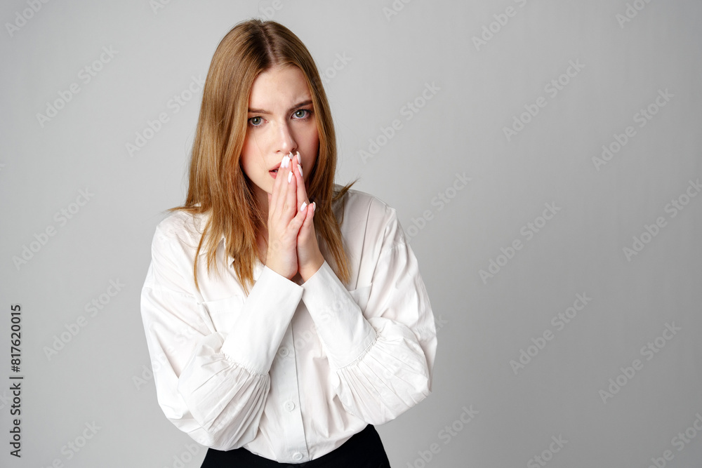 Young Woman in White Blouse Expressing Concern in studio Young Woman in White Blouse Expressing Concern in studio