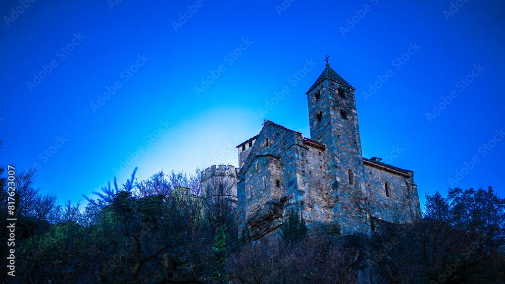 view of the Valere Basilica, an ancient fortified church in Sion, Canton of Valais, Switzerland. Blue sky. Sunrise view of the Valere Basilica, an ancient fortified church in Sion, Canton of Valais, Switzerland. Blue sky. Sunrise
